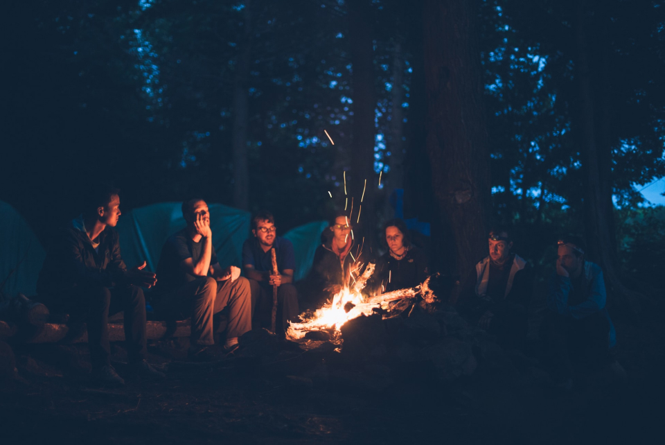 Group-Of-Friends-Sitting-Beside-Campfire