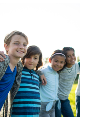 Children stand arm in arm